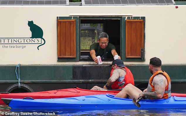 BERKSHIRE: Two kayakers stop off at Whiitington's Tea Barge to buy cans of beer on a hot and humid afternoon