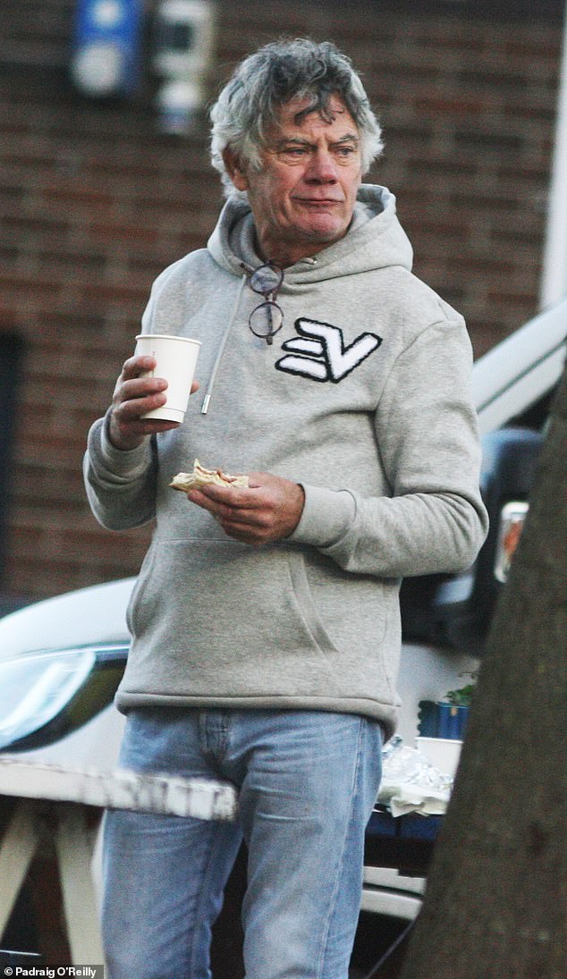 Gerry 'The Monk' Hutch pictured eating a breakfast sandwich on Sean MacDermott Street, Dublin, on December 2, 2024, while taking down his election posters after his defeat in the general election