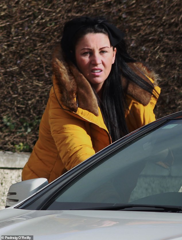Pictured: Simoan McEnroe wearing a bright yellow-orange puffer jacket lined with fur while getting into a car