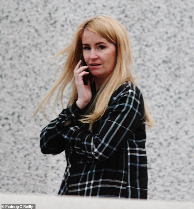 Anita Freeman talking on the phone while walking in the south Dublin neighbourhood of Crumlin, where she grew up