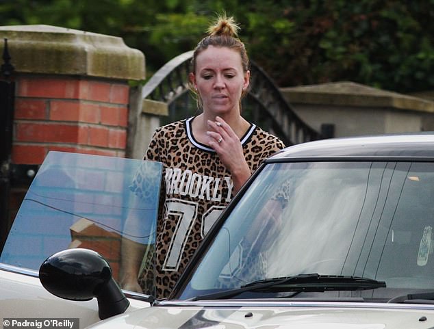 Photos of Kelly taken after David's death also showed her dressed in a leopard print top, black leggings and white Adidas trainers while smoking a cigarette and getting into a cream coloured Mini Cooper with black stripes on the bonnet