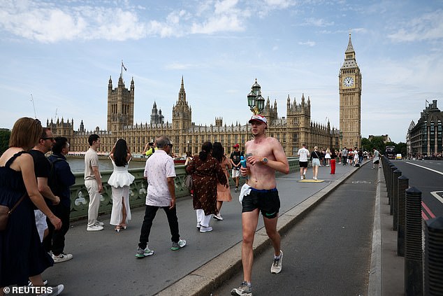 Today, Britain is as hot as the likes of Barbados and Corfu and is hotter than Barcelona and Lisbon (Pictured: A topless man jogs over Westminster Bridge, June 21, 2025)