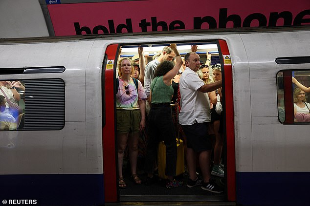 But forecasters at the Met Office warned that much of the UK could be soaked as soon as 5pm this evening as the humid aftermath of the heatwave looks set to result in a downpour (Pictured: Commuters squeeze onto a London Underground tube, June 21, 2025)