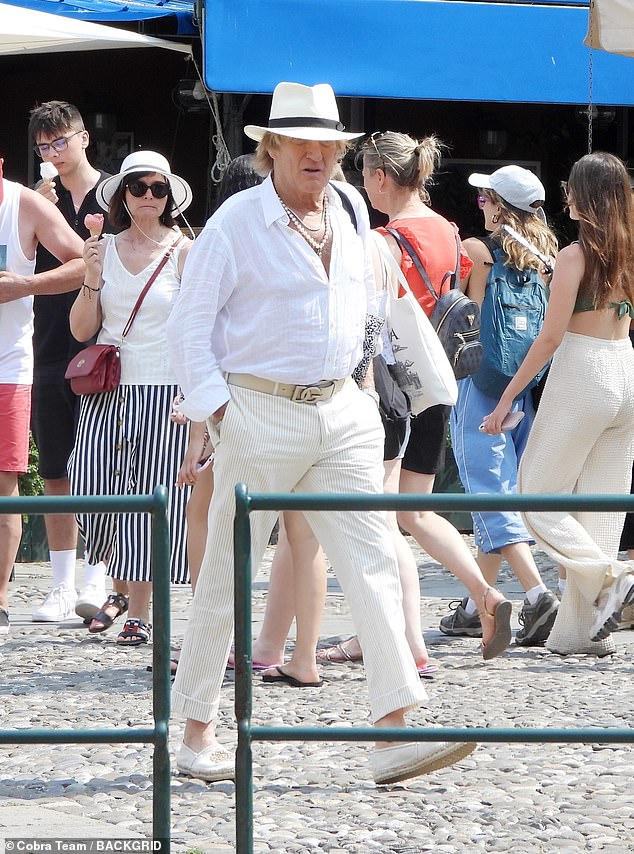 Meanwhile, Rod was aptly dressed for the warm weather as he cut a smart figure in a white shirt and cream, pinstripe trousers