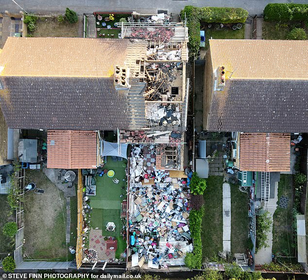 The extent of debri across the house garden is pictured. A neighbour said: 'The house has been in a terrible state ever since. It's a real eyesore'