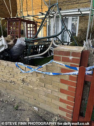 Police tape has even been strewn across the 'garden' wall