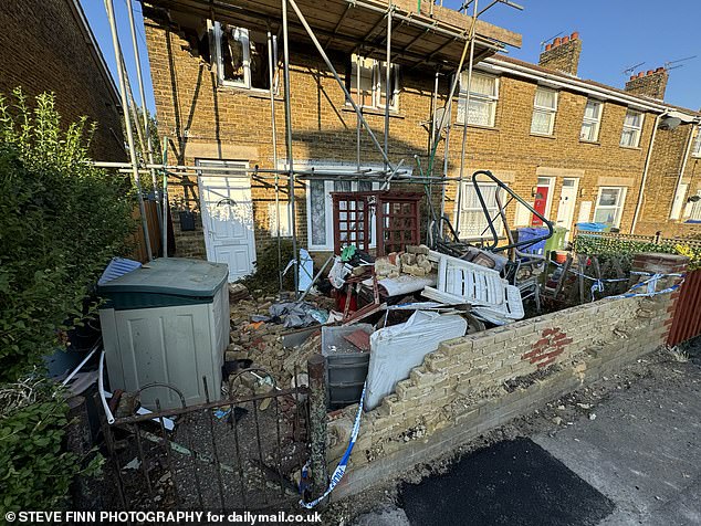 The back garden is also not the only garden filled with rubbish - the front 'garden' is no less of a state