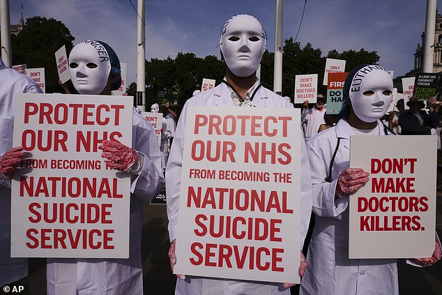 On Friday MPs narrowly voted the Bill through by 23 votes – 32 fewer than when they backed it in principle in November. Pictured: Demonstrators against assisted dying outside Parliament