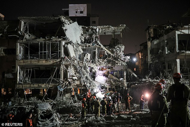 Khamenei vowed to 'inflict heavy blows' as he blames Israel for starting a war. Pictured: the skeletal remains of a building after a missile attack in Ramat Gan, Israel on June 13