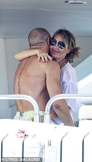Dee was wearing a white top and hugs her partner McGregor