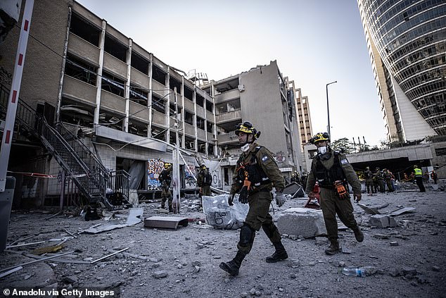 Police and civil defense conduct operations in the area following the missile fired from Iran that struck the city of Haifa in northwestern Israel on June 20