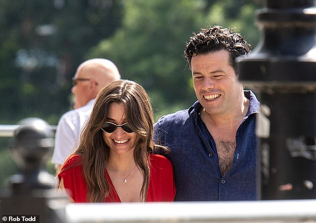 The pair share a joke as they walked along the River Thames near Barnes