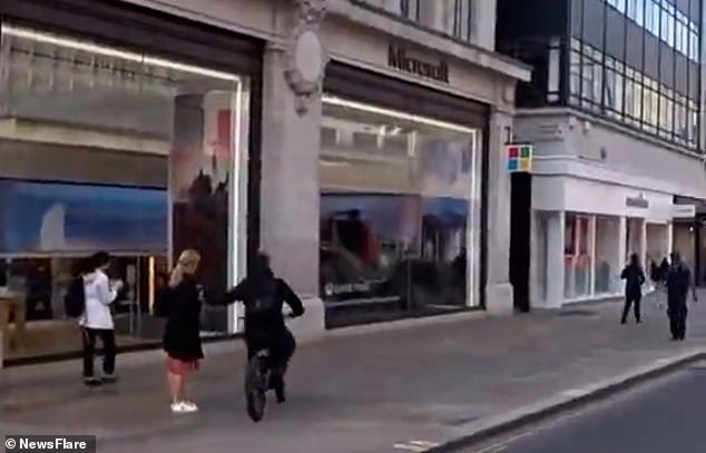 A woman's phone is snatched from her hand next to the Oxford Circus junction in London