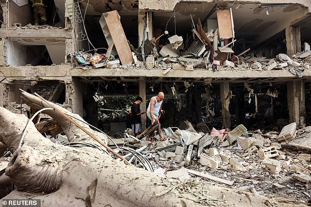 Residents evacuate from an impacted site after a missile attack from Iran