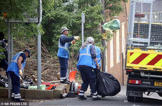 Council workers - wearing blue bibs citing 'Bradford 2025 - UK City of Culture' - were clearing mounds of dumped bin bags