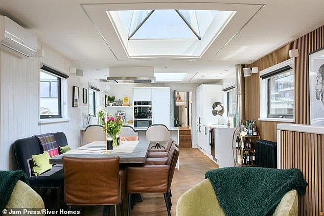 The main living room features warm wood panelling and a wood-burning stove that makes the space feel homely and rich in character