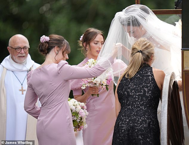 The clergyman who married the couple as Lady Violet arrives for the ceremony
