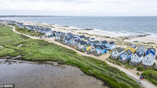 Mr Trickett found himself locked in a weeks-long feud with hut owners on the Spit (above), who said they would be 'traumatised' by the disruption of their sea views and the prospect of drunken revellers urinating off the vessel