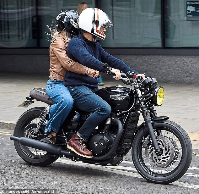 Helen was pictured with her arms wrapped round Gethin on the back of his motorbike earlier this month