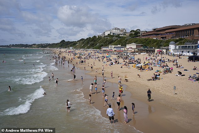 The sizzling sun came after experts at the London School of Hygiene and Tropical Medicine and Imperial College London (LSHTM) forecast that around 570 people could die due to the heat over the four days (Pictured: people enjoy the warm weather on a beech in Dorset on June 22