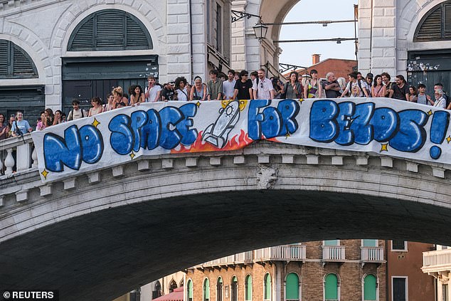 Protesters unfurled a huge banner with the message 'No Space For Bezos' over the Rialto bridge this week