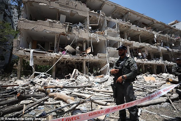 Despite Israel’s excellent air defences, Iran's missiles are getting through. Pictured, a building struck by the regime's rockets in Tel Aviv yesterday