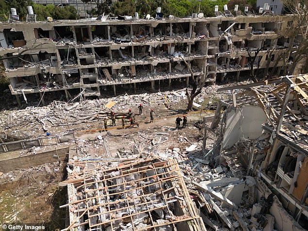 Emergency workers attend to a building hit by a reported Iranian missile strike on Sunday in the Ramat Aviv neighborhood of Tel Aviv, Israel