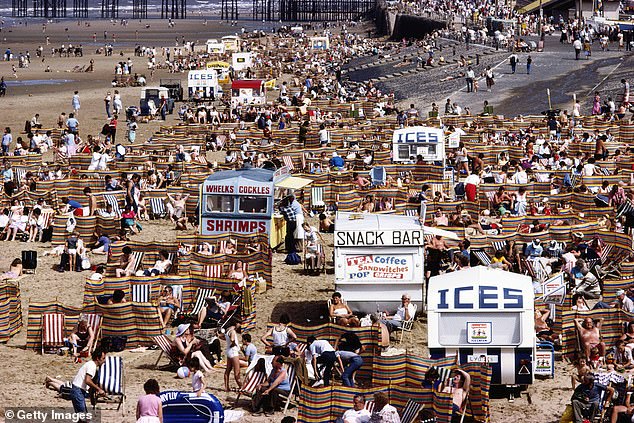 Crowds of holidaymakers and kiosks offering tea, coffee, ices, whelks and cockles and shrimps as snacks on the beach in the seaside resort of Blackpool, Lancashire, August 1983