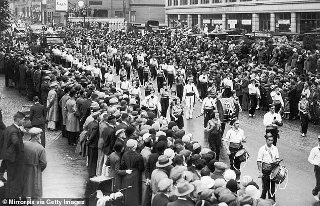 A carnival procession passes through Coventry in 1933