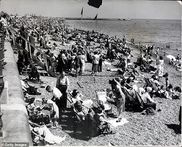 Holidaymakers are photographed on a crowded beach in Hastings on a Bank Holiday in 1951. Historic UK explains that 'in the 1950s and 1960s it was unusual for families to holiday abroad' and 'most stayed in the UK' for vacations