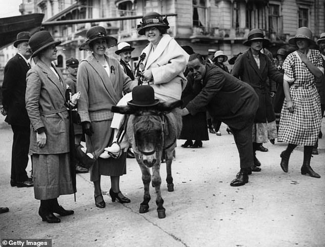 Above, another worker from the Ticklers Jam factory is pictured enjoying a donkey ride on a day out in Hastings in 1923. Donkey rides became popular at the British seaside during the 1800s but conditions could be tough for the animals