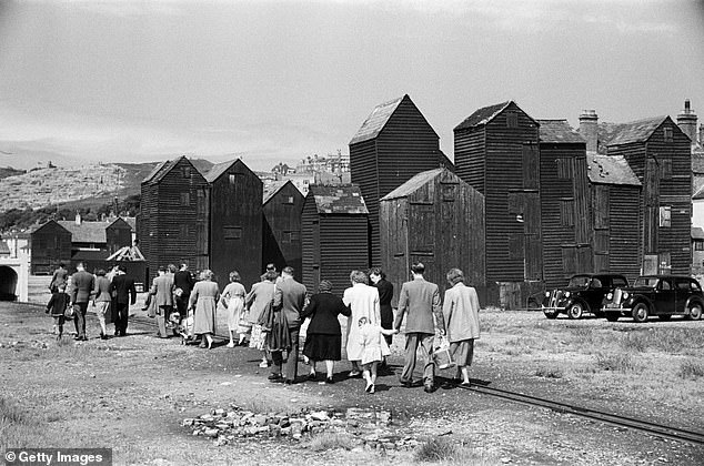 Hastings is one of the UK's oldest fishing towns with cod, plaice, sole and skate the most commonly caught fish. In the above picture, taken in 1952, tourists are seen walking past fishermen's huts, where the fishermen used to store their nets