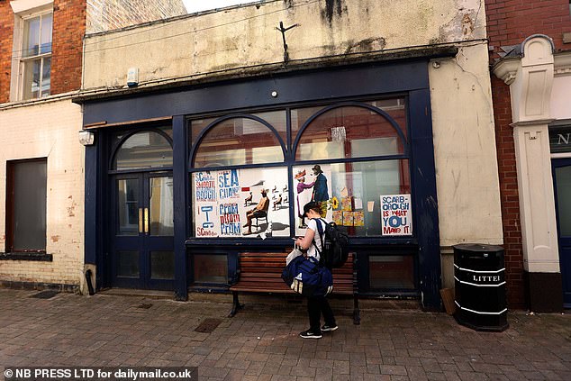 A local stands outside a shop in Scarborough earlier this month