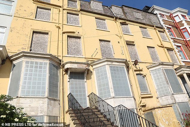 A derelict property in Scarborough is seen with metal shutters on its windows