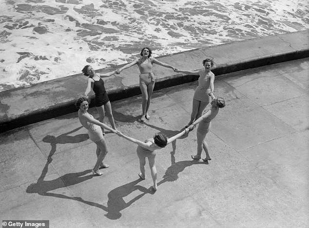 Bathing belles form a circle on the water's edge at Scarborough, North Yorkshire, June 1936