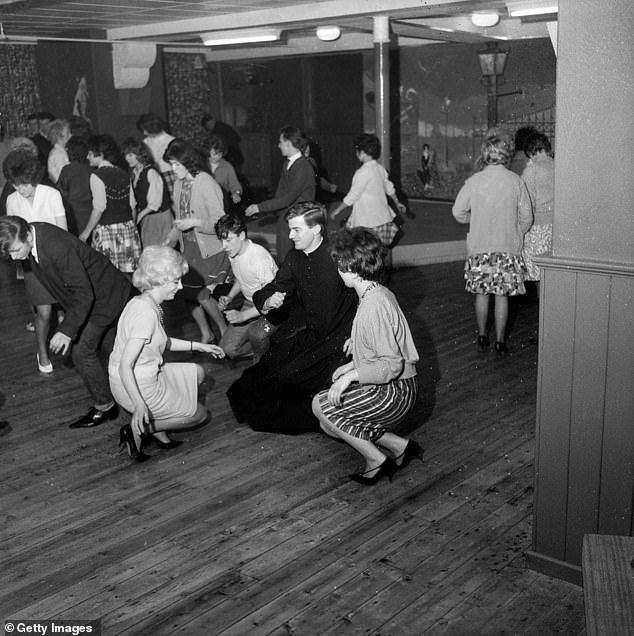 The Reverend Brother Timothy Campbell-Smith performs a vigorous twist routine at the Crypt Cat Club in Hall I' Th' Wood, near Bolton, Lancashire, 1962