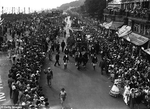 During the carnival in Southend in 1937, thousands of people are seen lining the promenade to see the procession