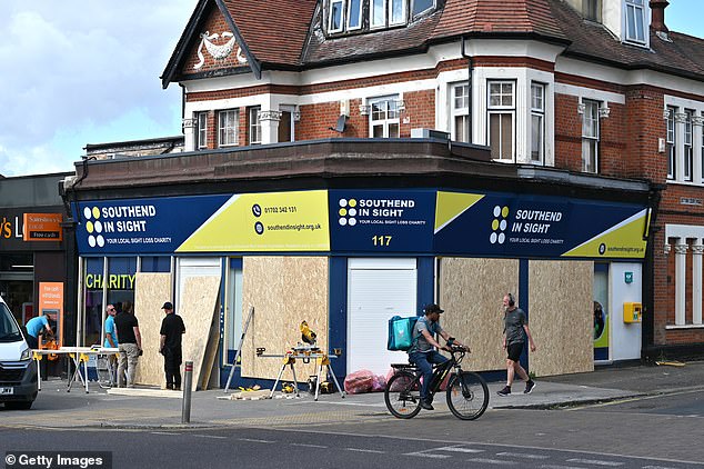 A charity shop is boarded up in Westcliff, a suburb of Southend, ahead of more unexpected unrest during last summer's protests