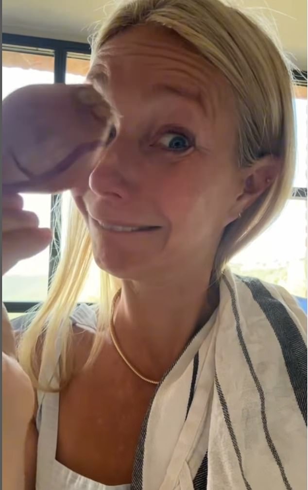 She then rung out all of the moisture from the potatoes in a kitchen towel before wiping tears away while holding up an onion before slicing it up