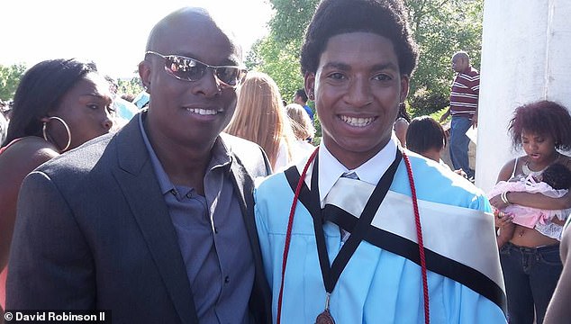 David Robinson smiles with his son Daniel at his college graduation