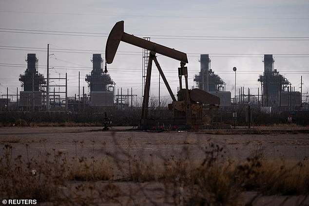 Gas prices in the US are rising due to the conflict in Iran (Pictured: A pump jack operates near a gas turbine power plant in the Permian Basin oil field outside of Odessa, Texas, in February)