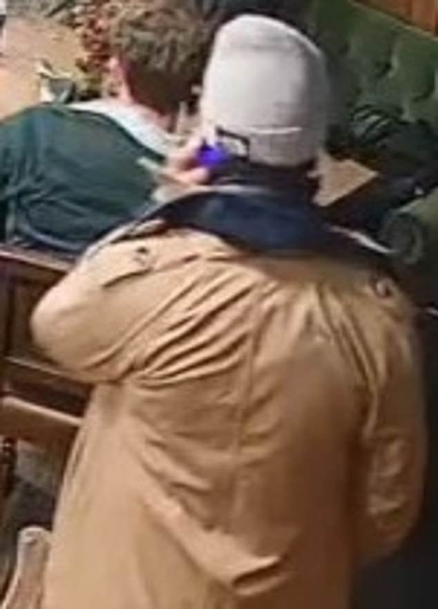 The suspect was wearing a pale beanie hat and light brown coat at the time of the incident