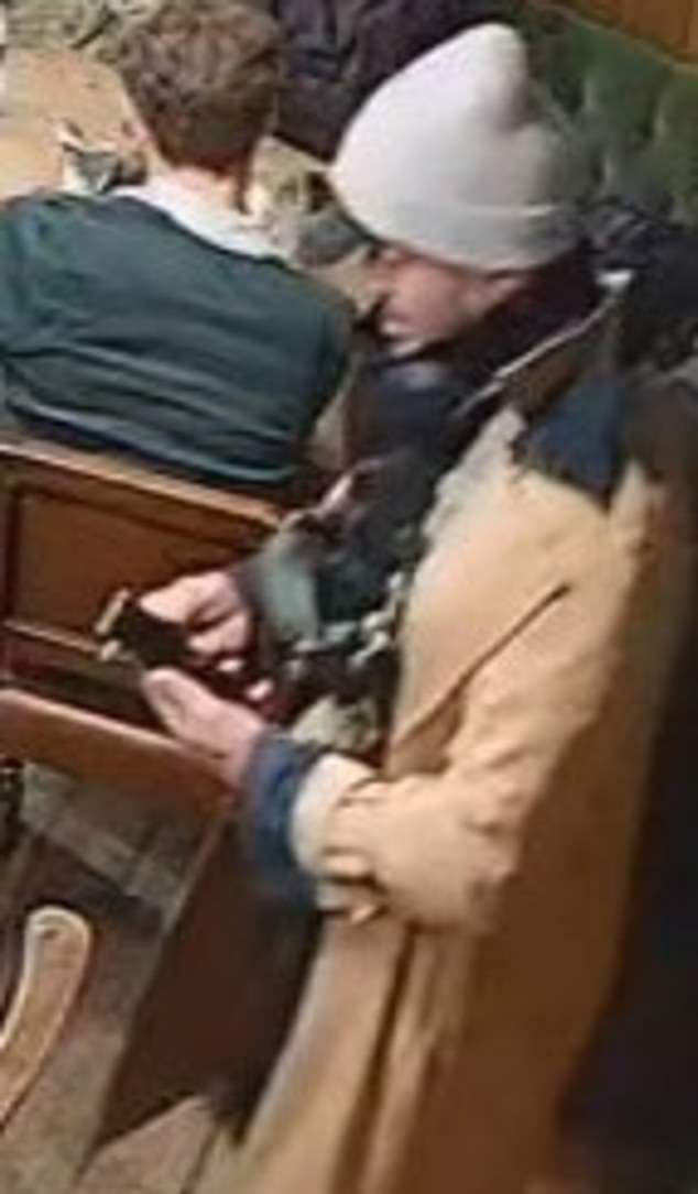CCTV released by the Metropolitan Police appears to show a male suspect walking into the pub on his phone