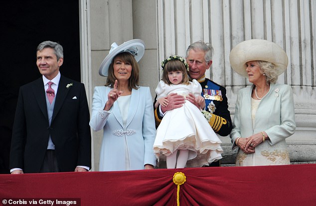 (L-R) Michael, Carole, Charles and Camilla are pictured with the step-granddaughter of Charles on the balcony at Buckingham Palace, just after the wedding of William and Kate