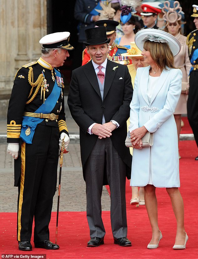 Charles talks with the father of the bride as they leave Westminster Abbey following the wedding of William and Kate