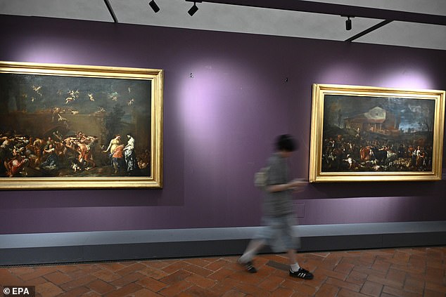 The painting was removed for repair, with experts concluding that the damage was relatively minor. Pictured: A person passes the wall of the Uffizi Gallery without the painting 'Portrait of Ferdinando de' Medici Grand Prince of Tuscany'