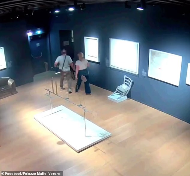 It was designed by Italian artist Nicola Bolla and is described by local media as being 'extremely fragile and delicate'. Pictured: The crystal-studded art is is left in a crooked state as the pair scurry out of the room