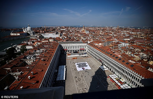 A team of former US marines has already been hired to provide security for the event by Bezos, which is due to take place over three days from June 26 in the iconic lagoon city. Pictured: A banner against Bezos lies on the ground in St. Mark's Square