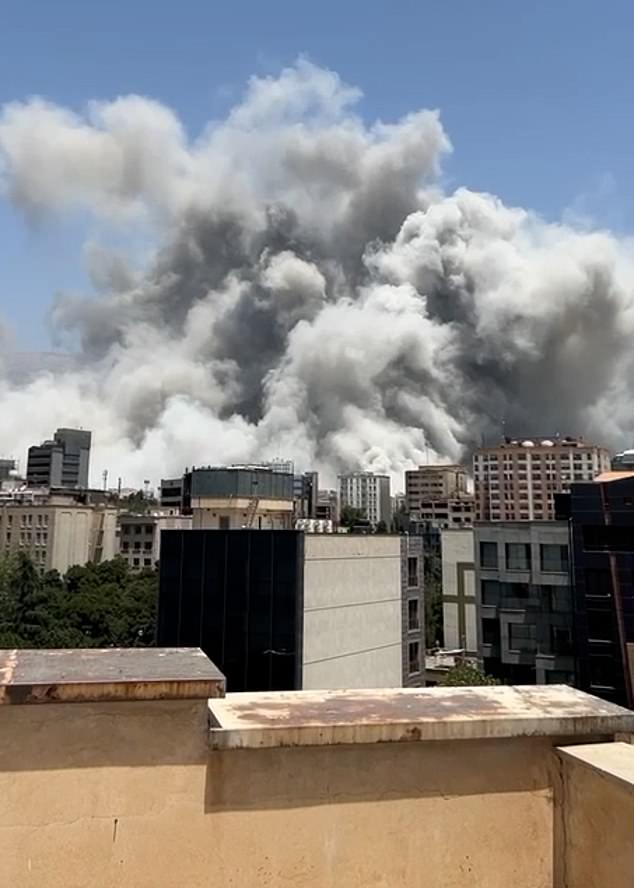 Pictured: A huge cloud of smoke billows over Tehran following an Israeli strike today