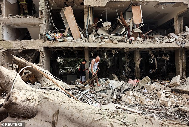 Residents evacuate from an impacted site after a missile attack from Iran